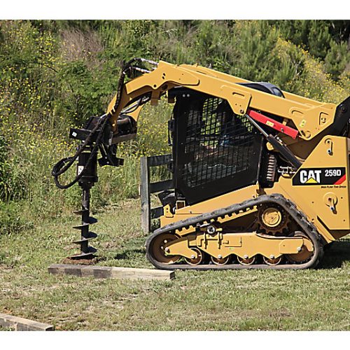 Skid steer loader CAT 259D drilling a hole